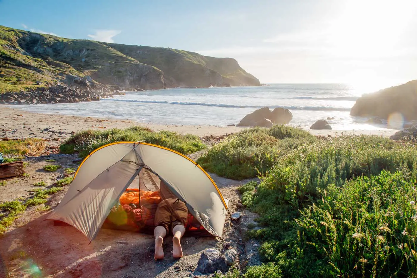 Man in a tent on the beach in Shark Harbor, Catalina Island