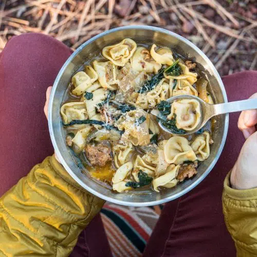 Overhead view of Megan holding a bowl of tortellini soup