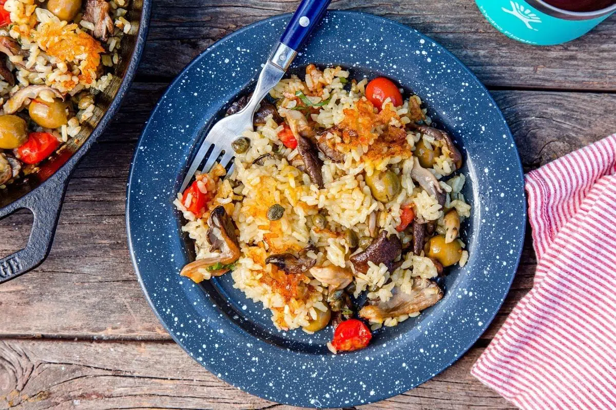 Paella on a plate on a wooden background