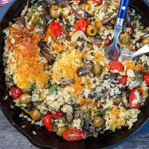 Vegan Paella in a skillet on a wooden table top