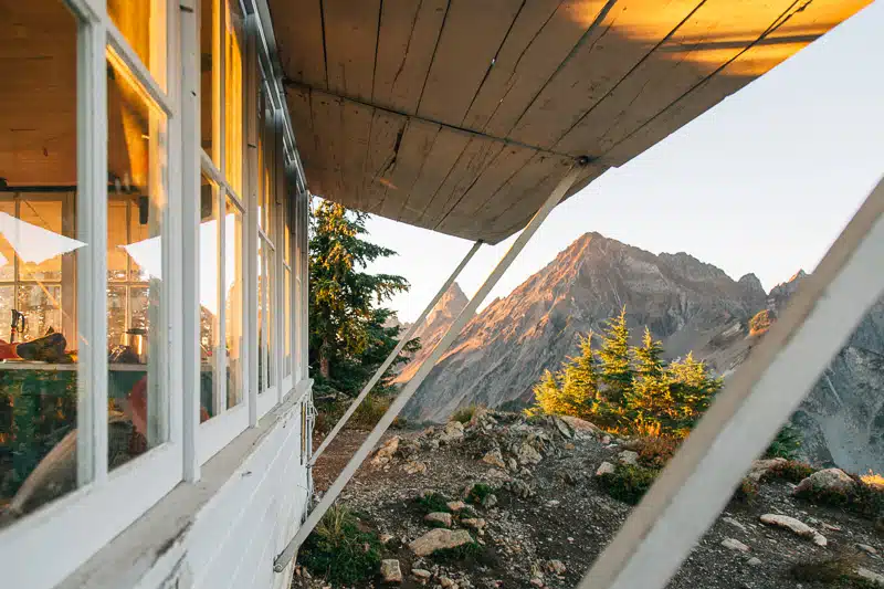 The side of Winchester Mountain fire lookout. Distant mountains can be seen passe the building.